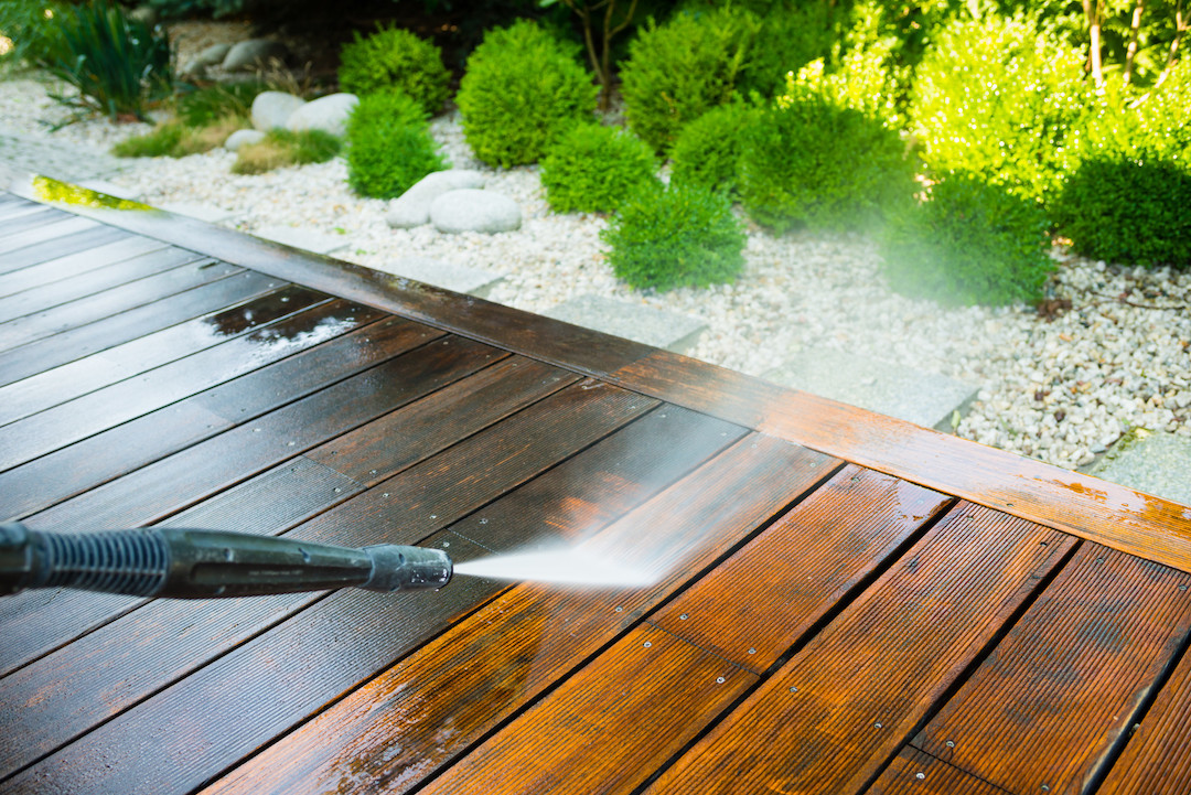 Image of a pressurewasher washing a wood deck.