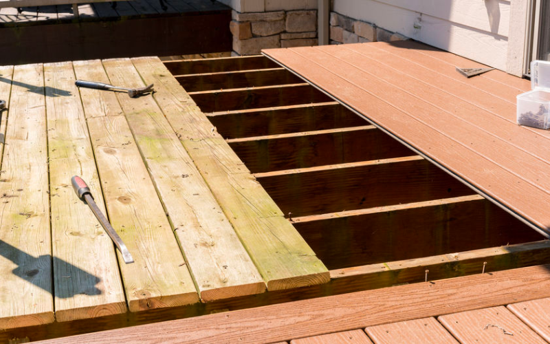 Image of person replacing a damaged deck board.